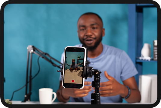 Person recording content with phone on stand